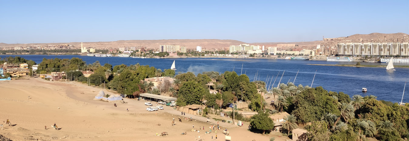 Traditional motorboat on the Nile River approaching Elephantine Island in Aswan