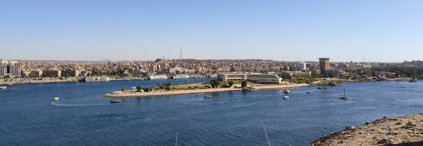 Panoramic view of the Nile River and desert landscape in Aswan, Egypt.