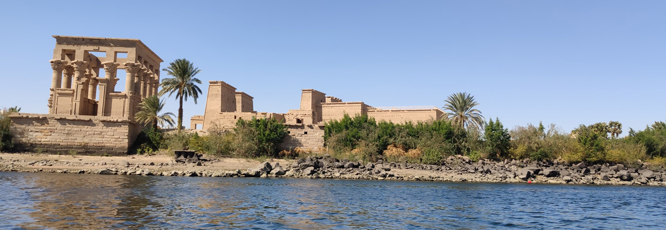 The majestic Temple of Isis on Philae Island, Aswan, reflected in the Nile.