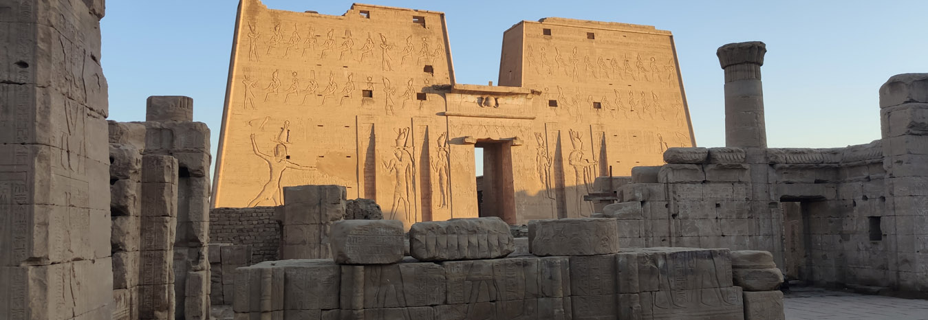 Ancient stone columns of the Temple of Isis on Philae Island, Aswan, surrounded by the Nile.