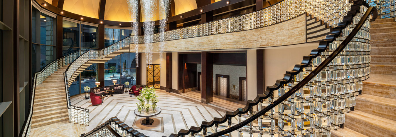 Modern and grand architectural design of the St. Regis Cairo Hotel, featuring premium marble and Pharaonic-inspired decor.