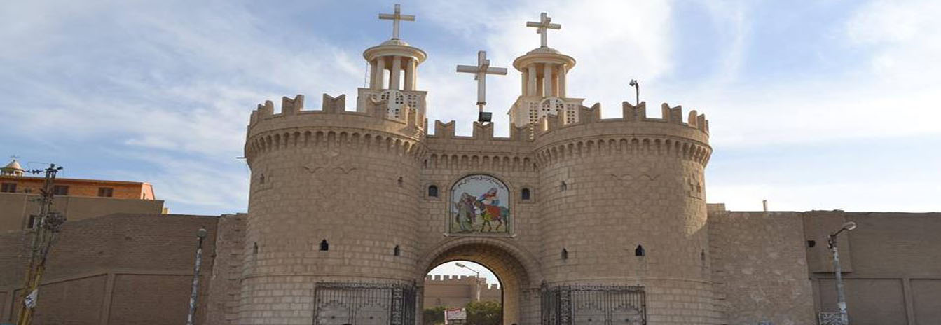 The ancient stone walls and bell tower of Al-Muharraq Monastery in Assiut, a key stop on the Holy Family's journey.
