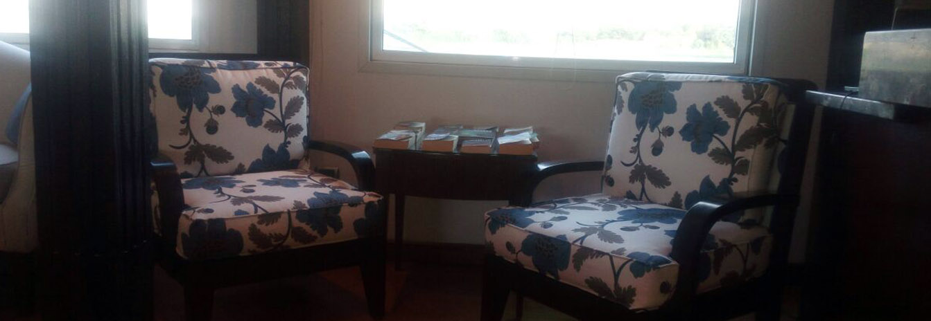 A luxury suite on the Dahbya Merit featuring large windows, Egyptian cotton linens, and classical decor.