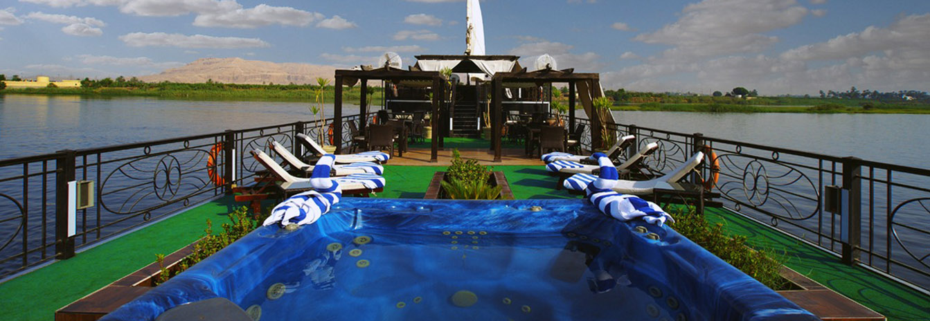 The luxury Dahbya Merit sailing boat with twin white sails on the Nile River near Luxor.