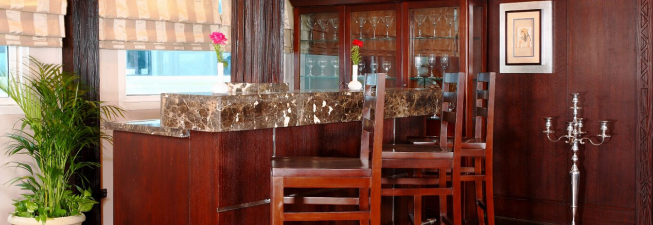 A luxury cabin on the Dahbya Merit featuring large windows and classic oriental decor.