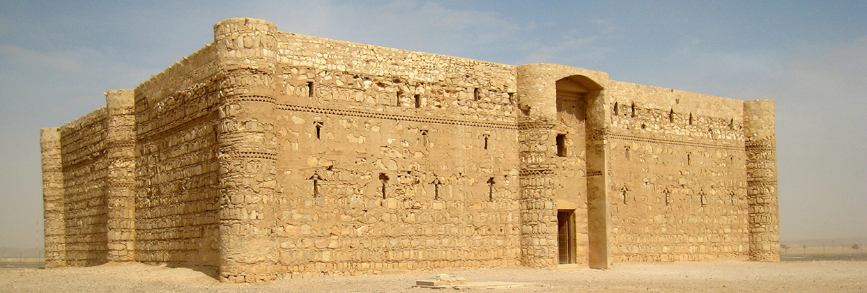 The stone architecture and fresco art of an Islamic medieval desert castle in Jordan