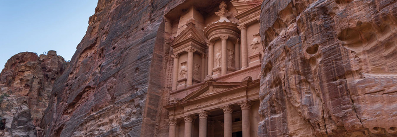 Detailed view of the sandstone cliffs and hand-carved tombs in the archaeological park of Petra, Jordan