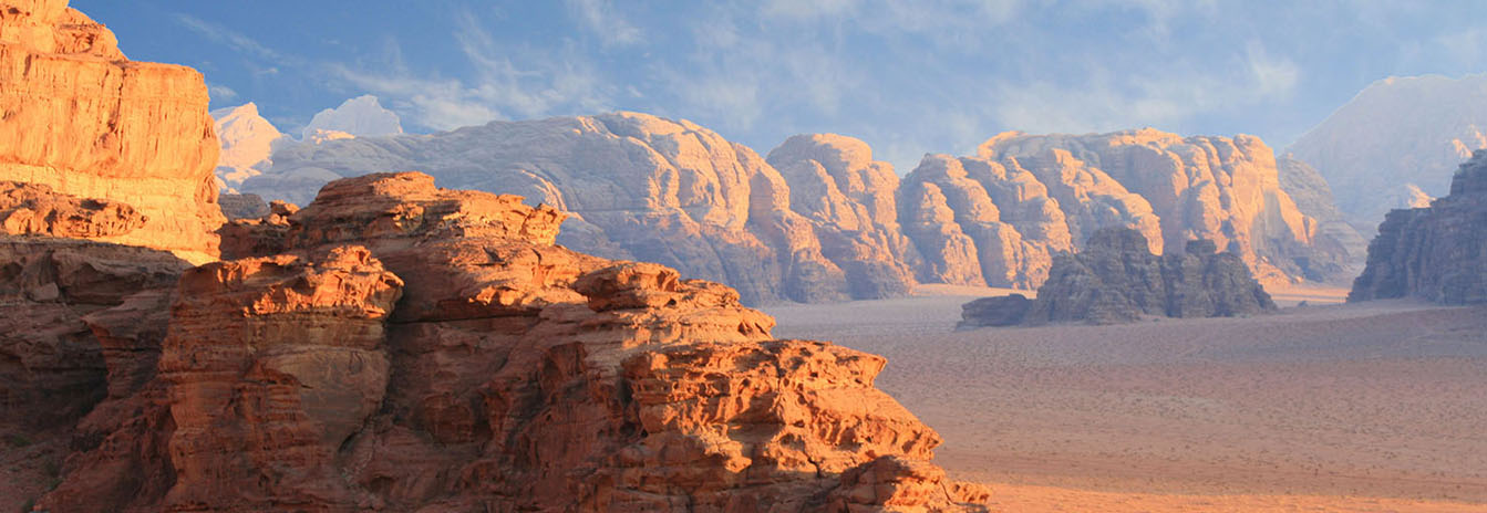 A 4x4 Jeep safari tour navigating the dramatic red sand dunes and towering rock formations of Wadi Rum Jordan