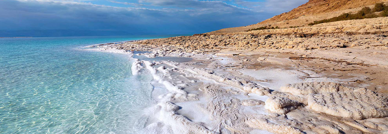 A traveler floating effortlessly in the salt-rich waters of the Dead Sea in Jordan at the lowest point on Earth