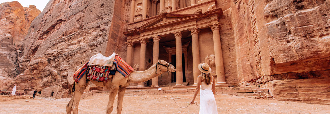 The iconic Al-Khazneh Treasury carved into the red sandstone cliffs of Petra Jordan – Highlights of Jordan 5 Days Tour