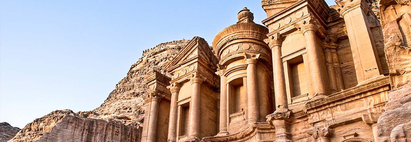 The iconic Al-Khazneh Treasury building carved into the red sandstone cliffs of Petra, Jordan