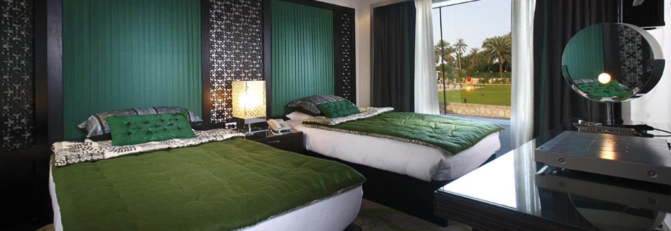 A refined guest cabin on the MS Darakum featuring a large panoramic window, warm oriental décor, and premium amenities.