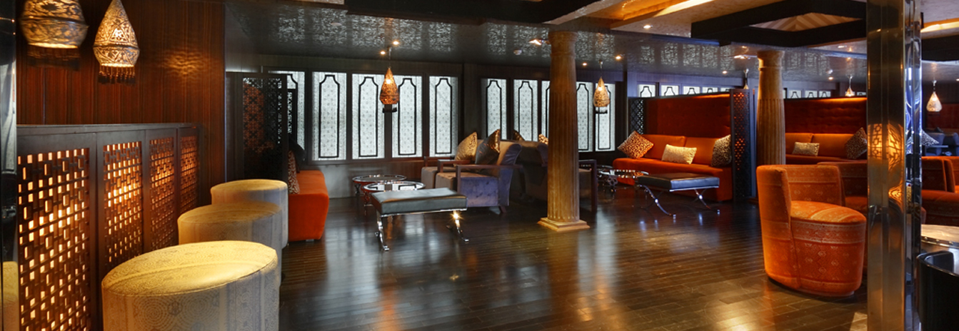 The ornate, mosaic-detailed main lounge of the MS Darakum featuring Moroccan arches and luxury seating.