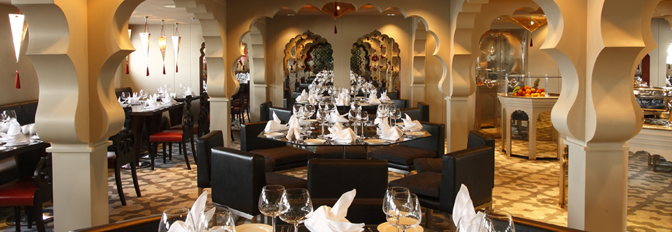 Elegant Moroccan-style dining room on the Mövenpick MS Darakum with ornate arches and formal table settings.