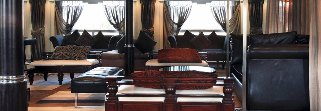 The spacious panoramic lounge on the MS Hamees with floor-to-ceiling windows and comfortable seating.