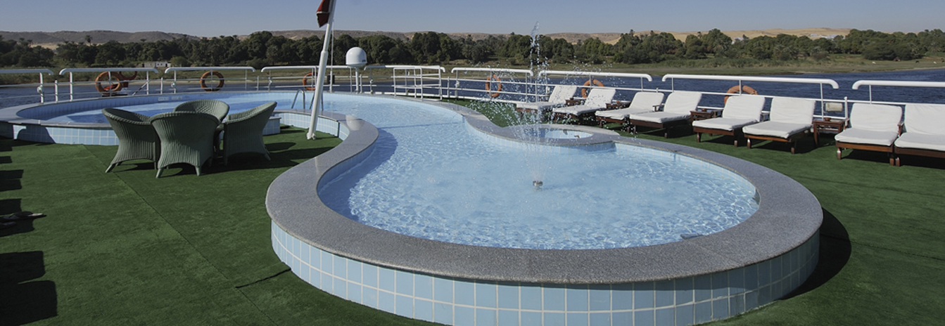 The large sun deck of the MS Hamees featuring a swimming pool, sun loungers, and river views.