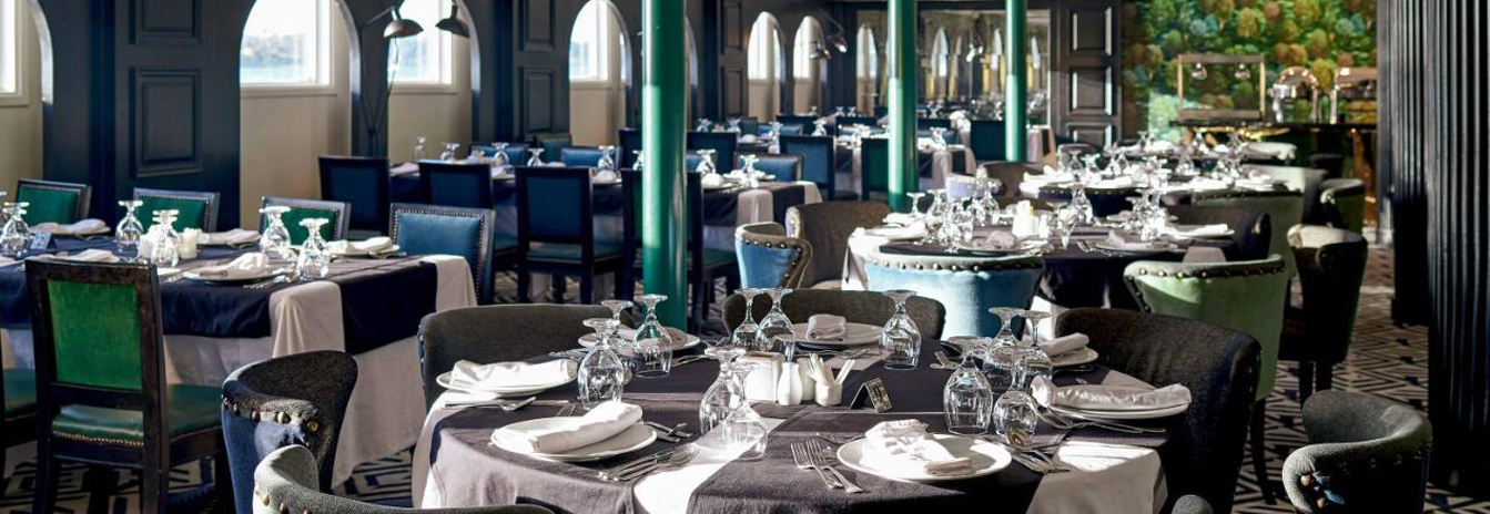 The elegant main dining room of the MS Hamees prepared for a gourmet buffet dinner.