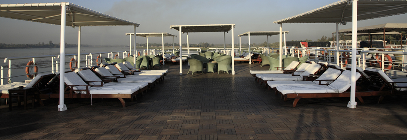 The expansive sun deck of the MS Hamees featuring a swimming pool and shaded lounge area.