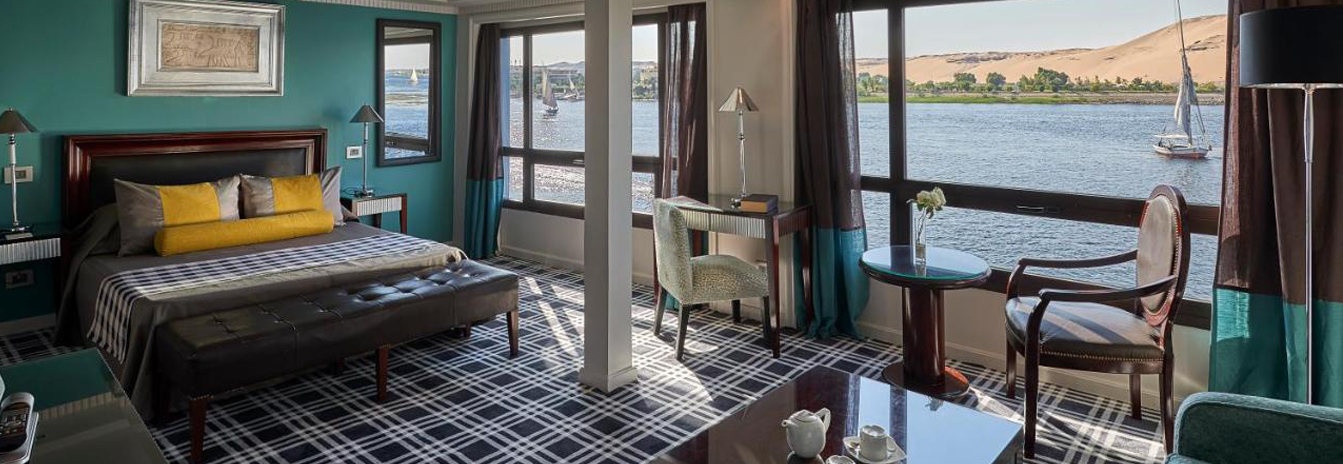 A modern, light-filled luxury cabin on the Mövenpick MS Sunray with floor-to-ceiling windows.