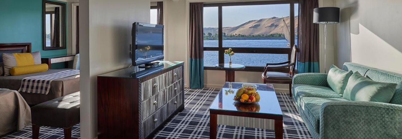 A modern, light-filled luxury cabin on the Mövenpick MS Sunray with floor-to-ceiling windows.
