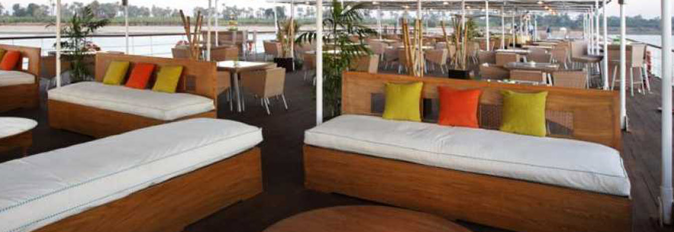 The expansive sun deck of a Mövenpick cruise ship featuring a swimming pool and shaded lounge area.