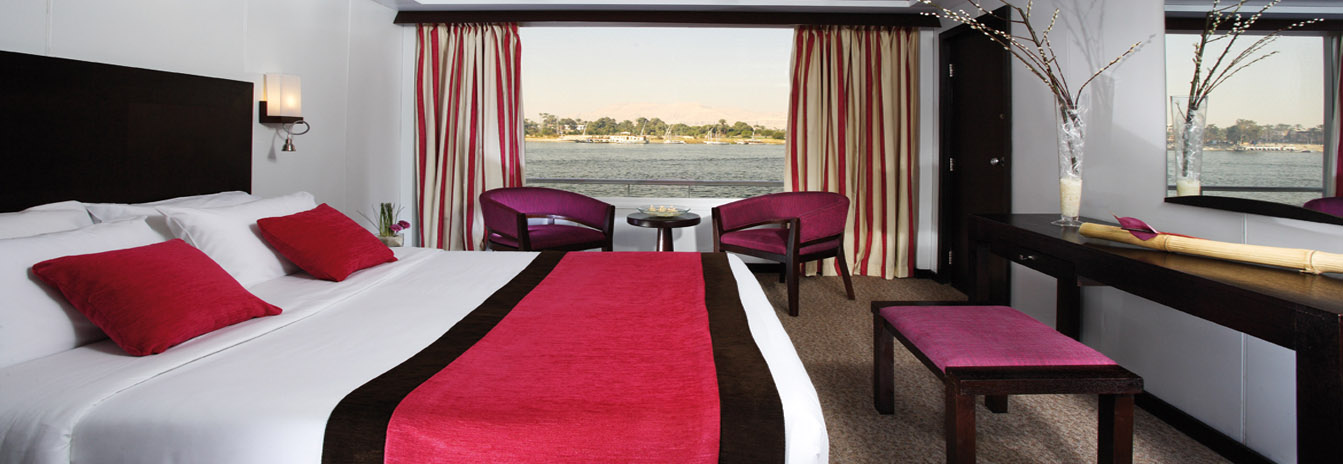 A contemporary luxury suite on the Mövenpick Nile Cruise featuring large panoramic windows and modern Swiss design.