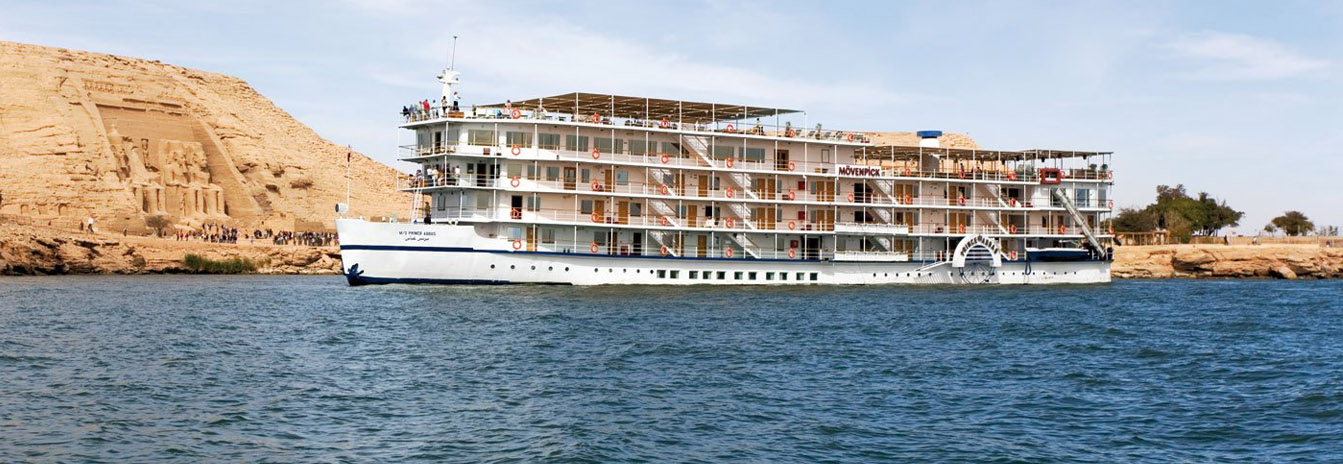 The 5-star Mövenpick Prince Abbas cruise ship sailing on the calm blue waters of Lake Nasser, Egypt.