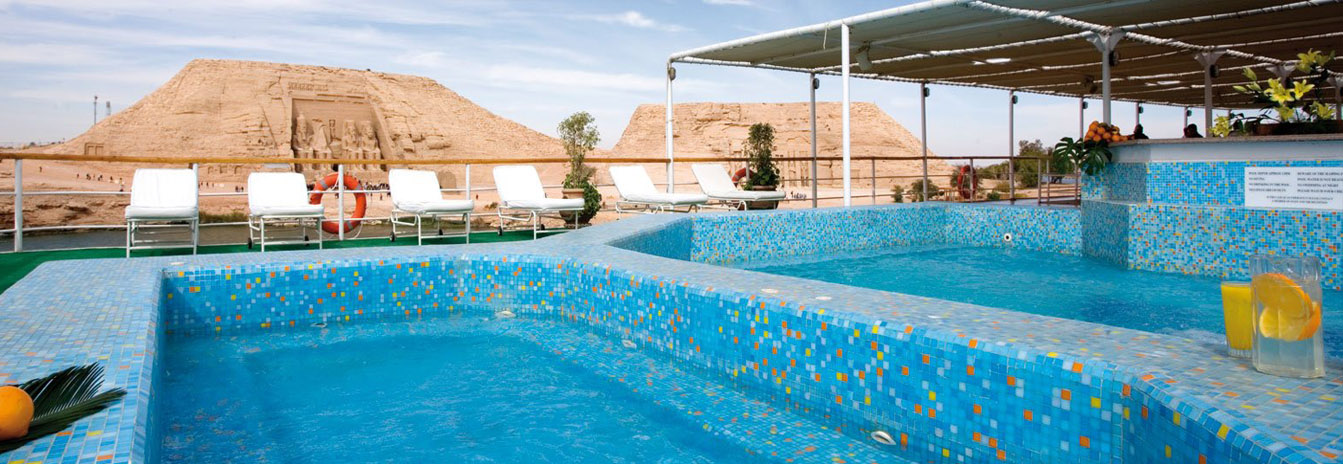 The expansive sun deck of the Prince Abbas featuring lounge chairs and panoramic views of the desert horizon.