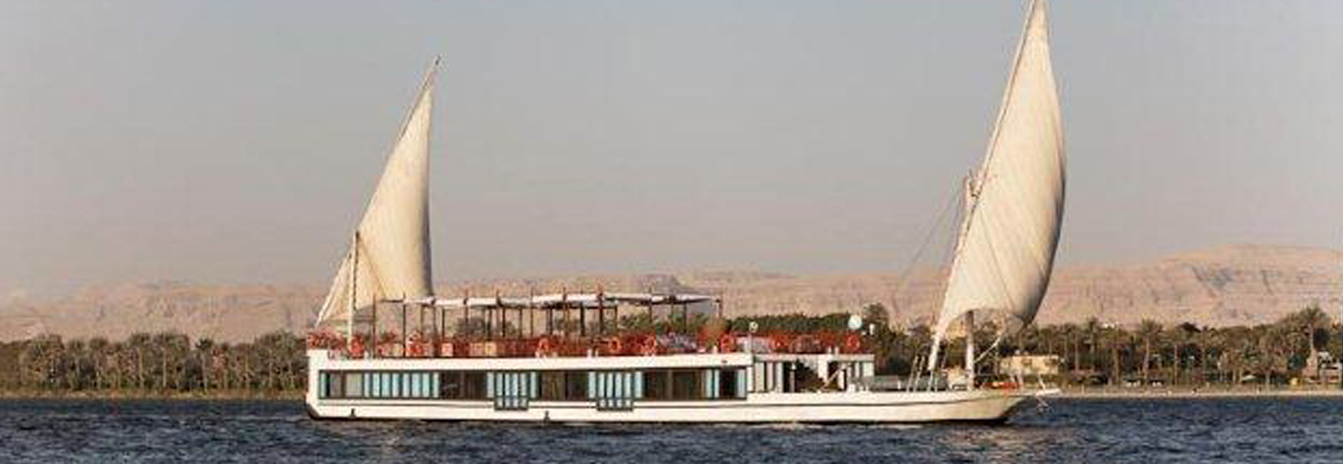 The luxury Mövenpick SB Feddya boutique sailing vessel with traditional twin sails on the Nile.