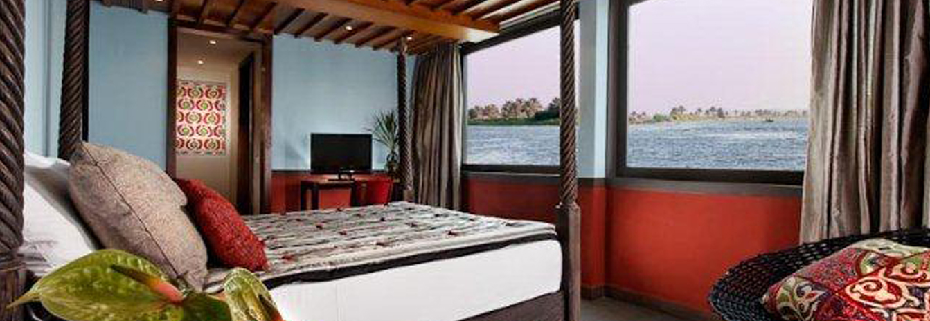A designer suite on the Mövenpick SB Feddya featuring large panoramic windows and modern decor.
