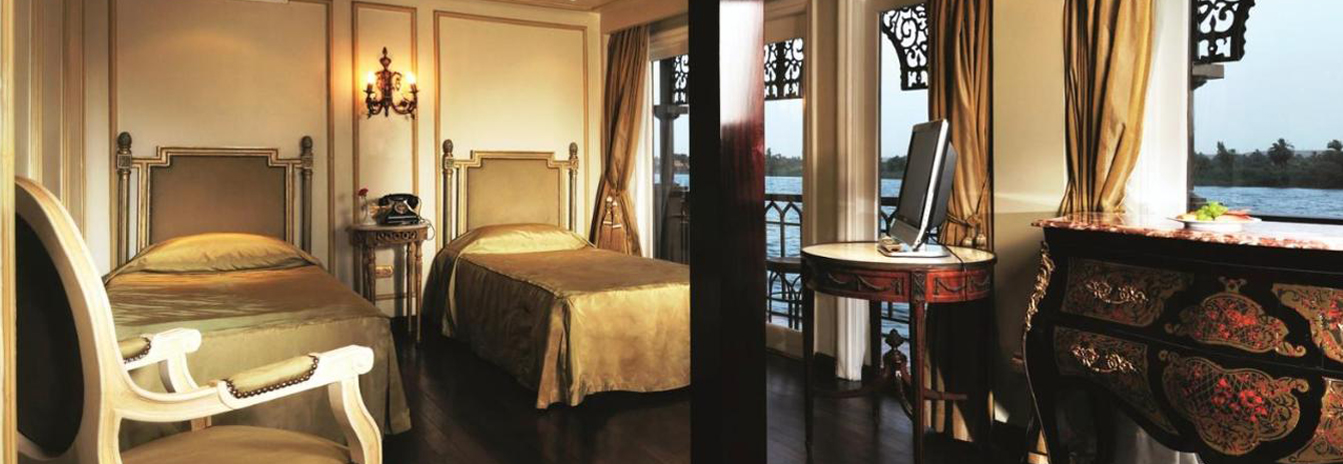 Luxury suite on the Mövenpick SS Misr with vintage-style furniture and a view of the Nile.