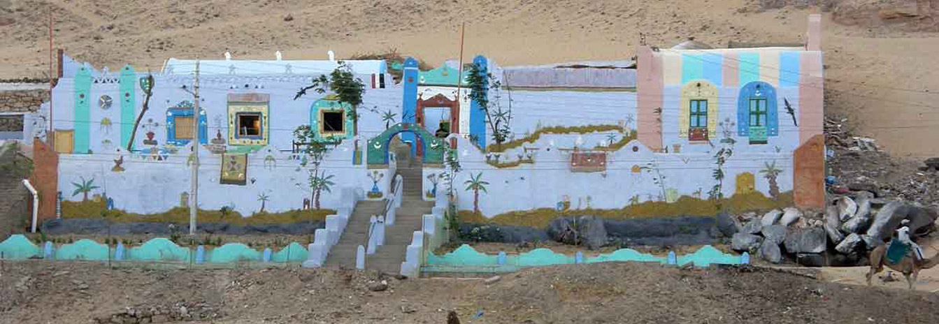 Brightly colored houses and traditional local market in a Nubian village along the Nile in Aswan.