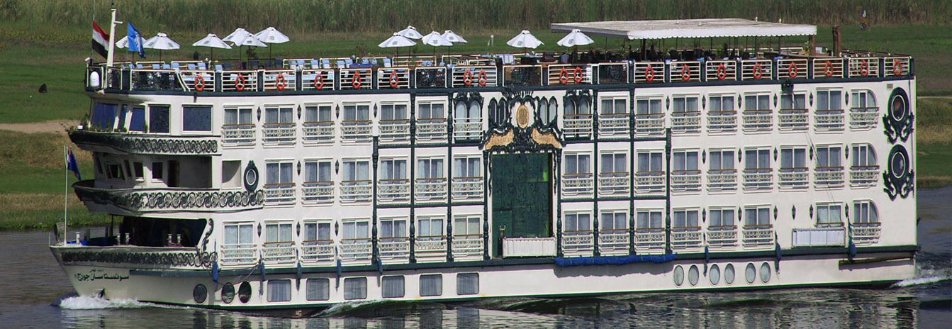 Luxury Sonesta St. George I Nile Cruise ship with French-style architecture sailing near Aswan, Egypt.