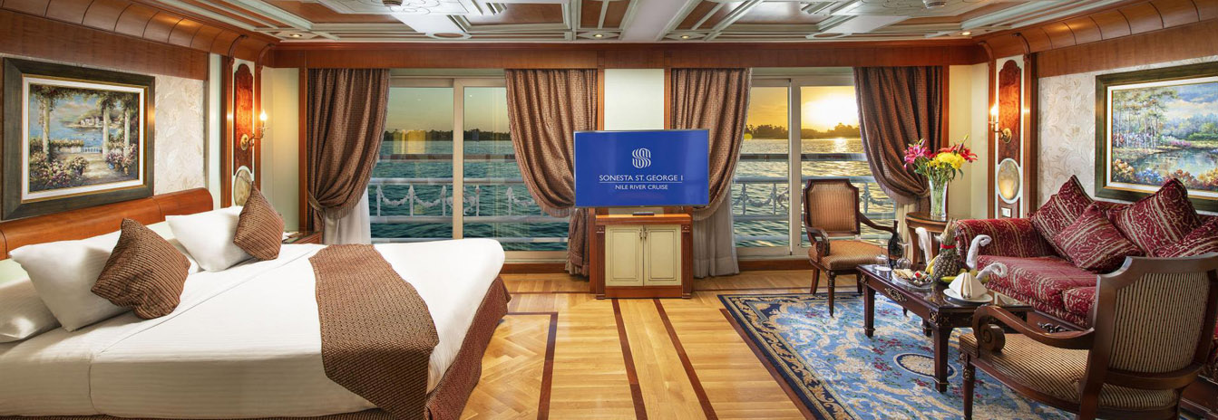 Luxury Deluxe Suite on the Sonesta St. George Nile Cruise with French-style decor and panoramic windows.