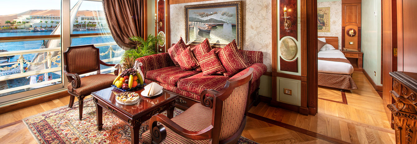 A luxury cabin on the Sonesta St. George Nile Cruise featuring a large French balcony and views of the Nile banks.