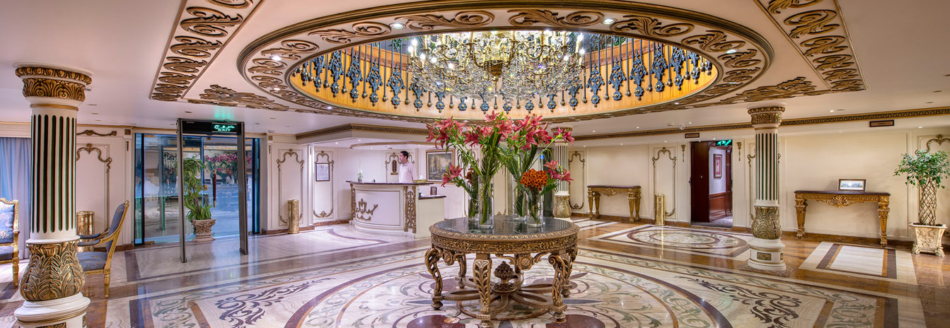 The grand French-style lobby and gold-leaf staircase of the Sonesta St. George Nile Cruise ship.