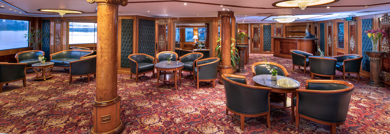The 5-star Sonesta St. George I Nile Cruise ship docked in Aswan, featuring its signature French-style architecture.