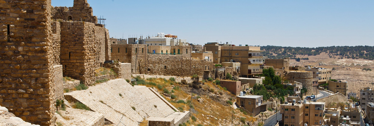 The massive stone fortifications and arches of the Crusader-era Kerak Castle in Jordan.